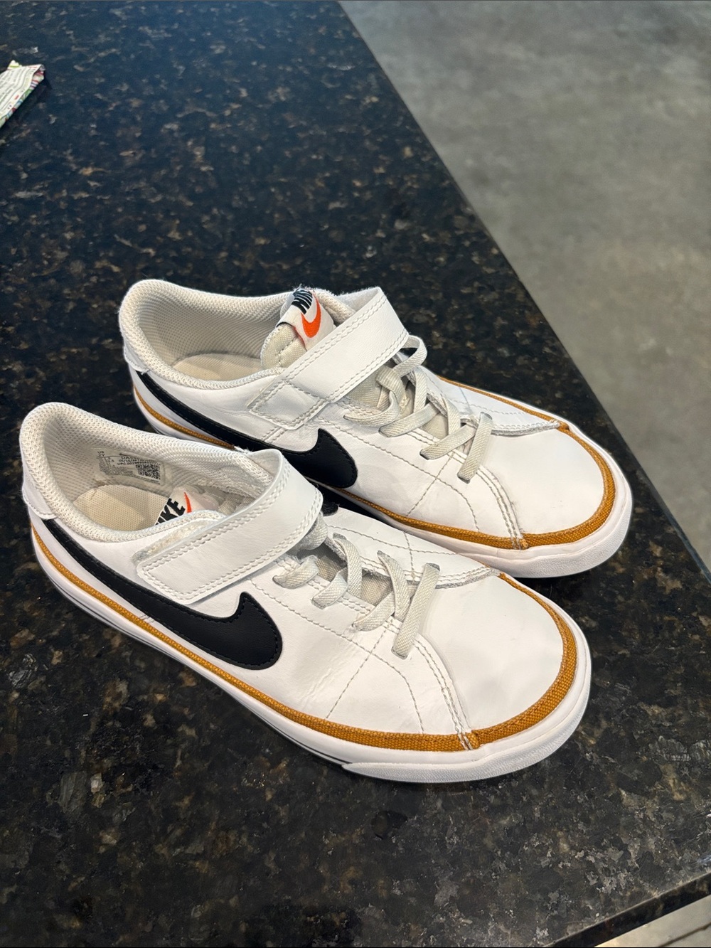 Nike Kids White Sneakers with Black Swoosh and Gold Trim